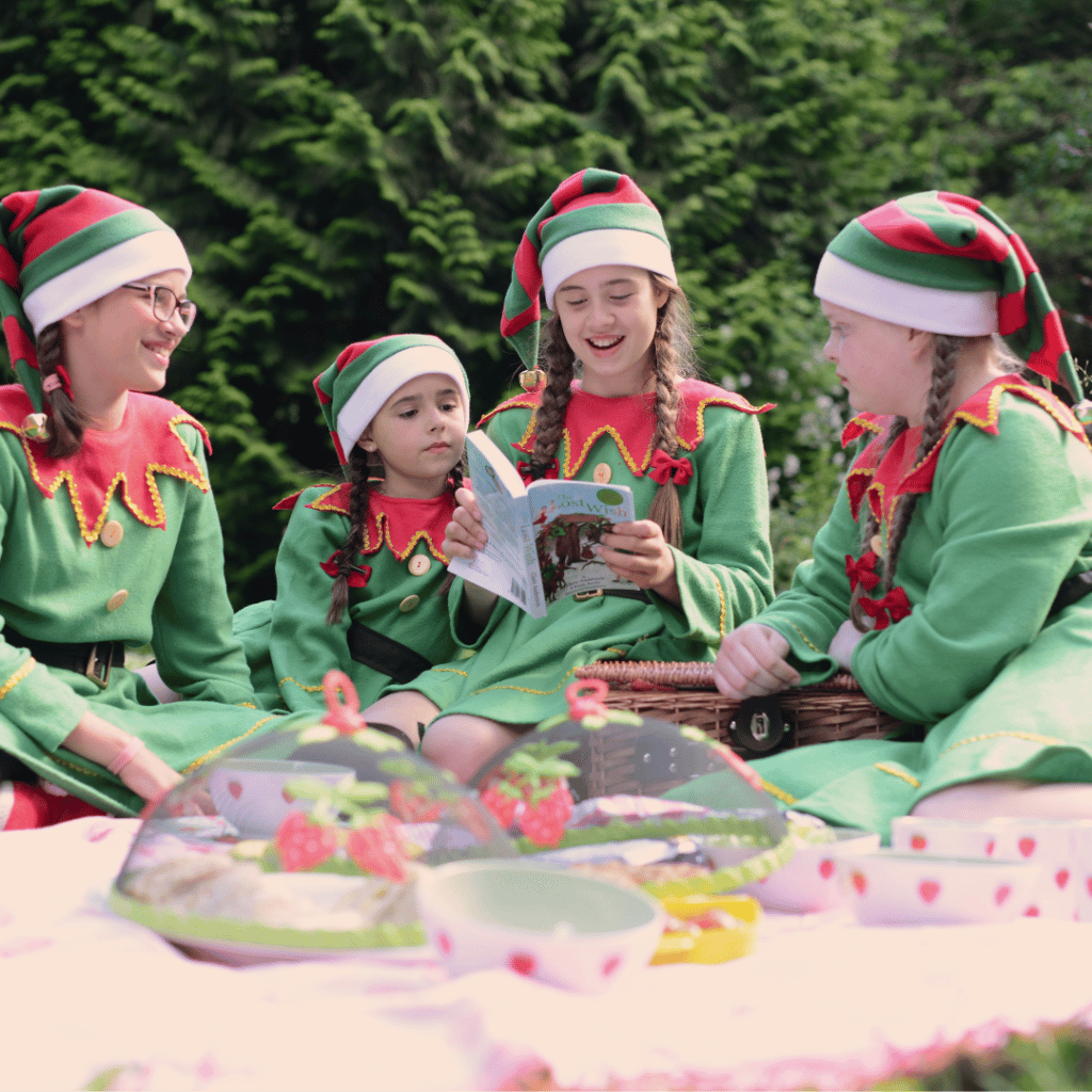 4 Girls Dresses as Elves Reading The Lost Wish During A Picnic in the Woodlands