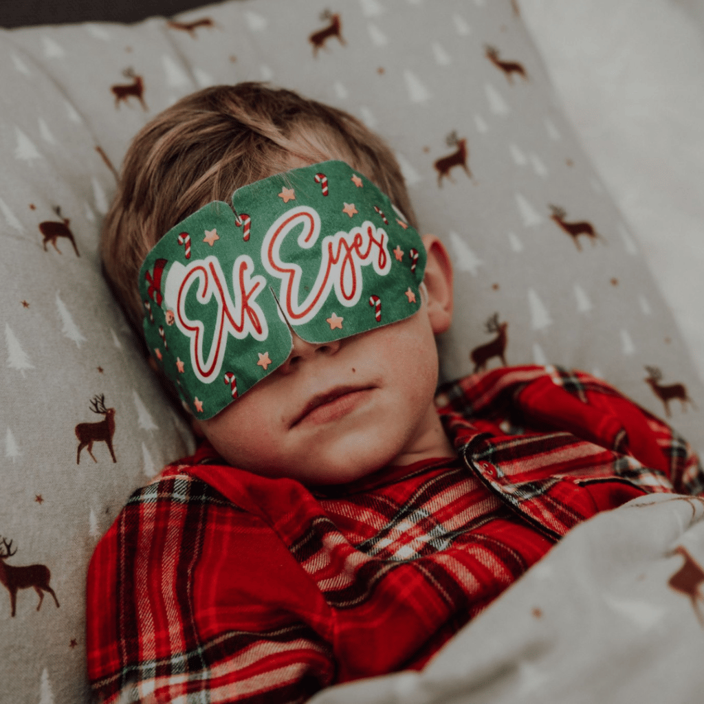 Young Boy in Grey Reindeer Bedding with Elf Eyes Mask