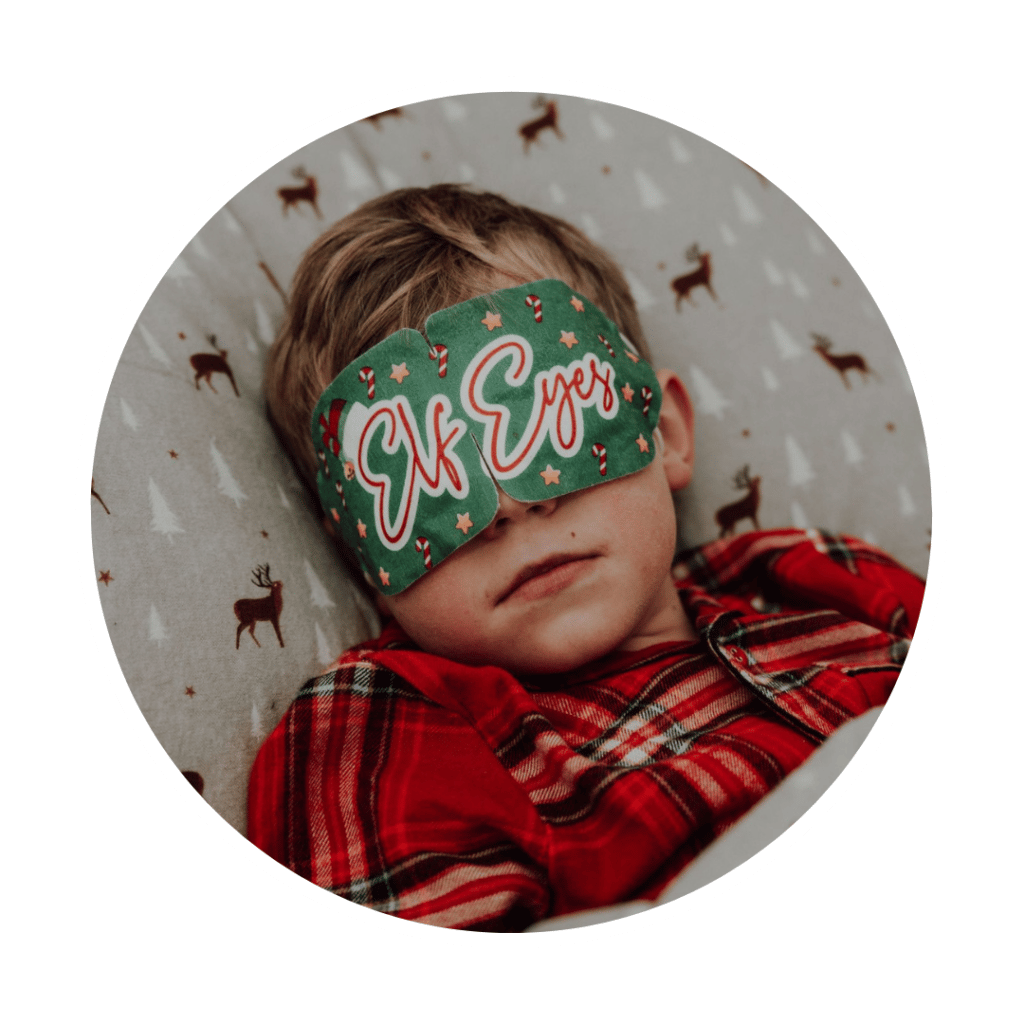Young boy sleeping in elf eyes mask