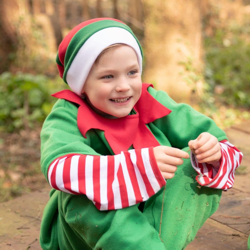 young boy dressed as elf smiling